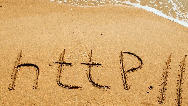 The word http handwritten in sand on a beach