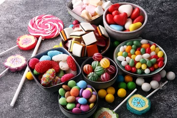 Wall murals Sweets candies with jelly and sugar. colorful array of different childs sweets and treats