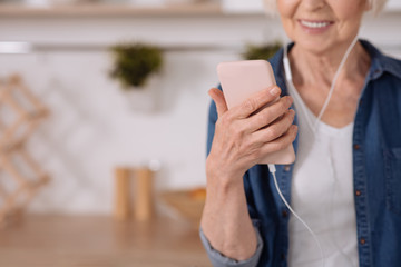 Positive senior woman using her smartphone