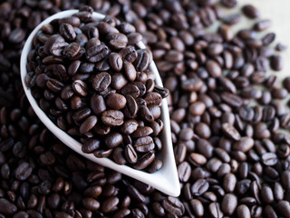 Black coffee seed in ceramic bowl or cup