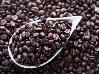 Black coffee seed in ceramic bowl or cup