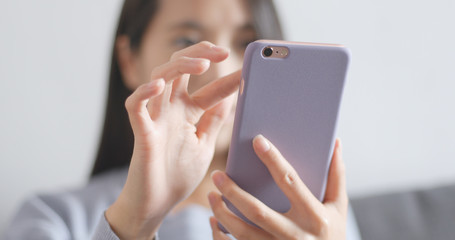 Woman using mobile phone at home