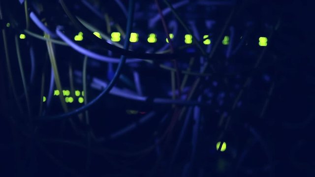 Operating equipment in the data center. Server room in the dark. Video in a low key. Without noise and artifacts. IT concept. Warning: the video with quality sound.