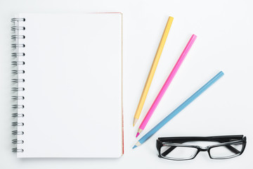 Notepad, pencils and glasses