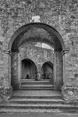 Fototapeta na wymiar Black and white view of Porta and Fonti di Docciola, walls of Volterra, Pisa, Tuscany, Italy