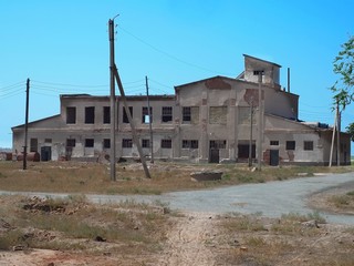 Old ruined fishing factory in middle of desert, Aral Sea ecology disaster, Uzbekistan