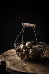 quail eggs in bascket, rustic wooden  background