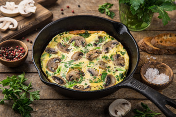 omelette with mushrooms on cast iron pan