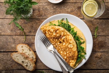 omelette with spinach, green peas and arugula for breakfast