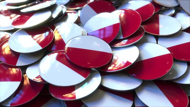 Pile of badges featuring flags of Poland or Monaco