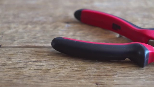 Regular pliers on wooden board slider shuting
