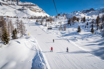 Skiers on a ski track on a beautiful sunny day in the Alps