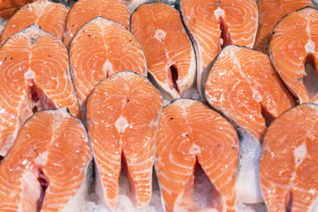 fresh appetizing salmon steaks in ice