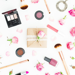 Gift box, pink roses and cosmetics on white background. Top view. Flat lay. Woman day consept.