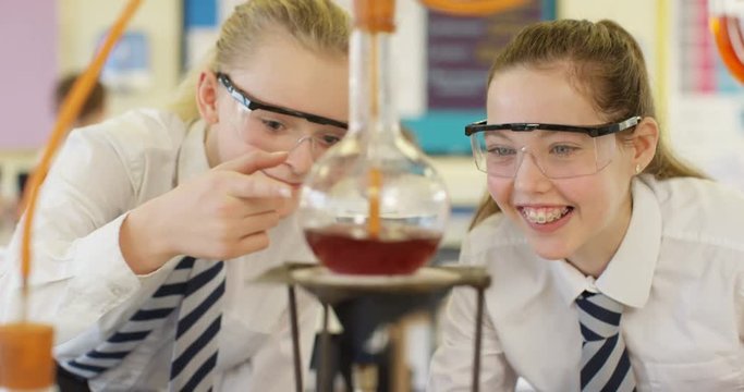 4k, Two young students looking excitedly at a science experiment. Slow motion.