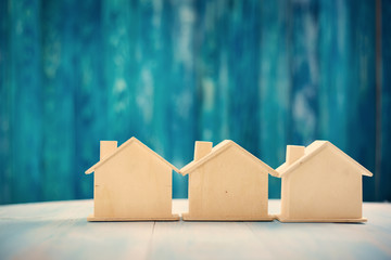 house models on blue wooden background. Property concept.