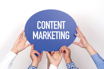 Group of people holding the CONTENT MARKETING written speech bubble
