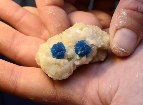 blue cavansite mineral found in Pune, India, on a blue background