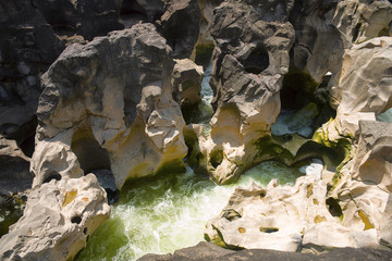 Naturally created potholes (tinajas) on the riverbed of the Kukadi River, Nighoj