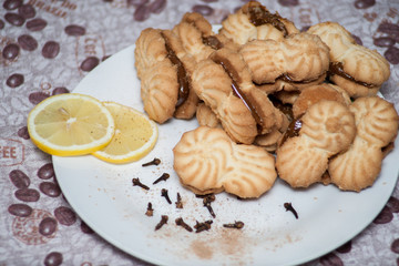 cookies on a plate with condensed milk with lemons under a coffee