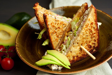 Top view of Healthy Sandwich toast with lettuce, ham, cheese and tomato on a wooden background