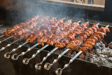 Kebab on metal skewers on grill. Appetizing shashlik.