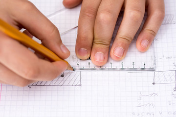 Schoolboy Hands with Ruler Drawing on White Paper. Mathematics Concept.