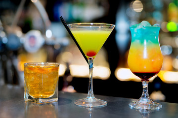 Whisky sour and colourful tropical cocktails on bar