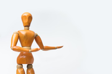 Wooden figure pose raising arm hand to introduce product for business.white isolated background