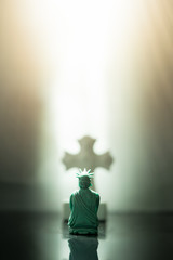 Back view of The Statue of Liberty bow down and praying to GOD and Jesus christ.God Bless america and good friday concept.