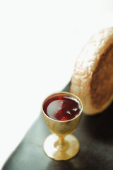 Holy communion on wooden table on church.Taking holy Communion.Cup of glass with red wine, bread.The Feast of Corpus Christi Concept.