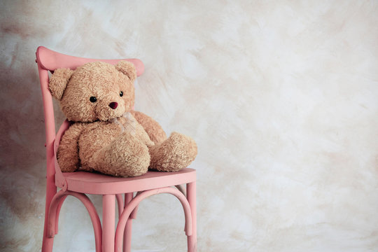 Sadness and Loneliness Concept. Lonely Teddy Bear Toy Siting Alone on Chair in House