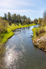 Fototapeta na wymiar River flowing through a valley in the spring