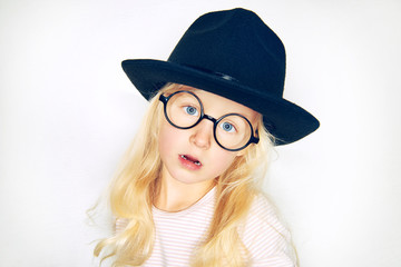 Little stylish blonde girl looking at camera