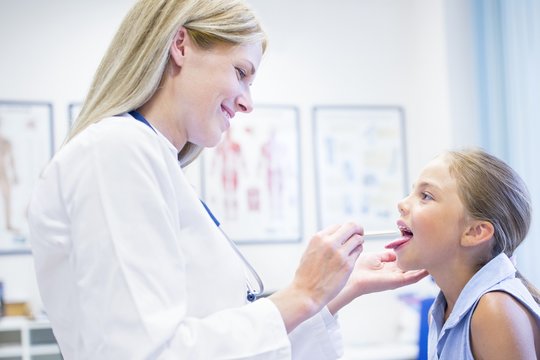 Doctor examining girl