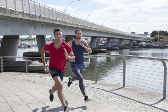 Two Men Running By River