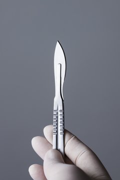 Person holding scalpel