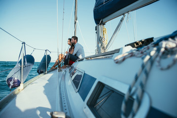 happy couple taking a romantic cruise on the sail boat