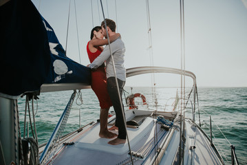 happy couple taking a romantic cruise on the sail boat