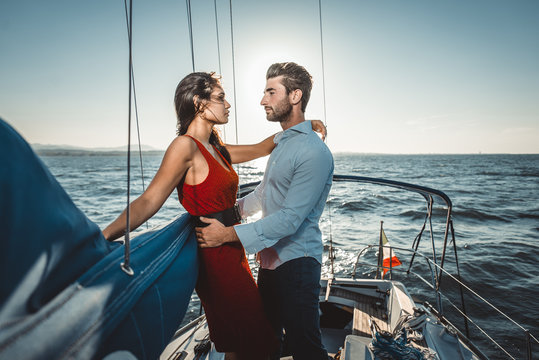 happy couple taking a romantic cruise on the sail boat