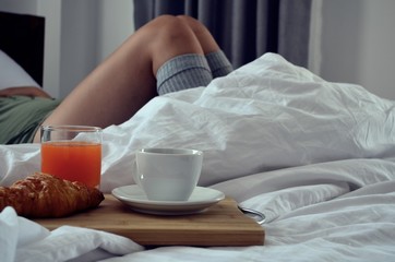 Fototapeta na wymiar Breakfast in bed, beautiful relaxed woman is lying on the bed,