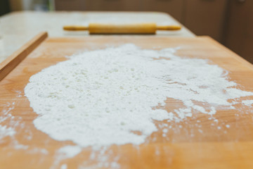 Baking class or recipe concept on dark background. Baking preparation, top view on wooden board or table. Cooking dough or pastry.