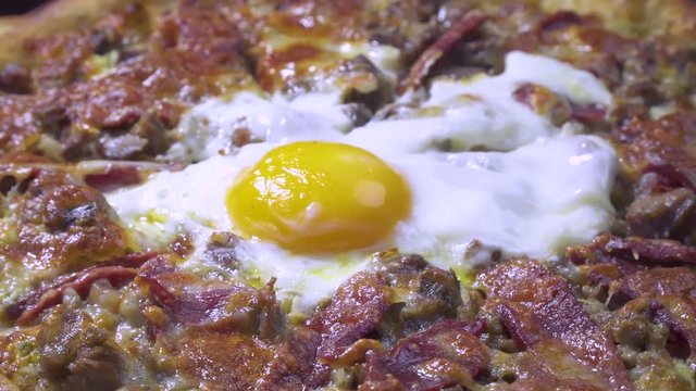 Delicious Turkish and Arabic Traditional Ramadan Food Pide, Lahmacun and Turkish Pizza serving with egg on rotating plate. Round, thin piece of dough topped with minced meat, vegetables and herbs