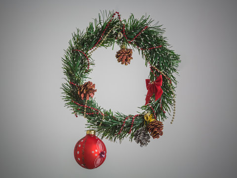 Christmas fresh natural wreath from spruce branch with red bow on grey background. Square image