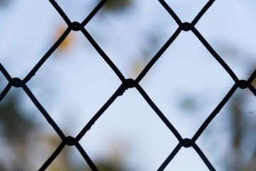 Steel wire mesh fence on a blurred background