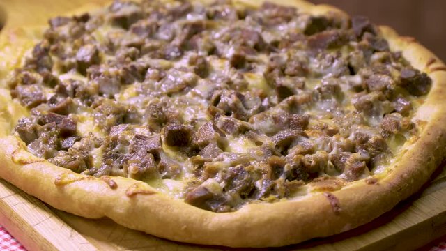 Turkish and Arabic Traditional Baked Ramadan Food Pide or Pizza ingredients with sliced halal lamb meat , butter, cheese and spicy herbs. Rotating shot. Copy space for text area.