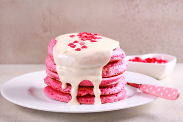 Red pancake stack with white chocolate topping
