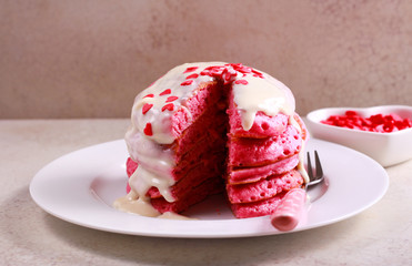 Red pancake stack with white chocolate topping