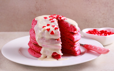 Red pancake stack with white chocolate topping