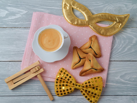 Hamantaschen cookies on table with coffee cup